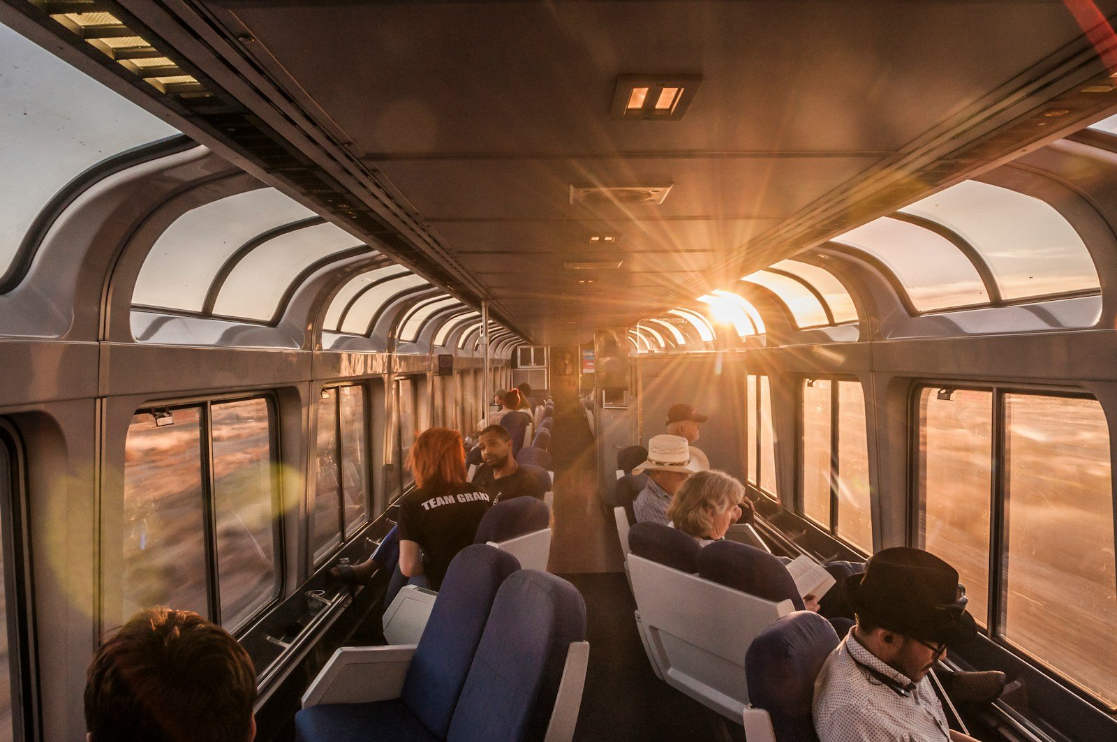 a group of people sitting on a train next to each other